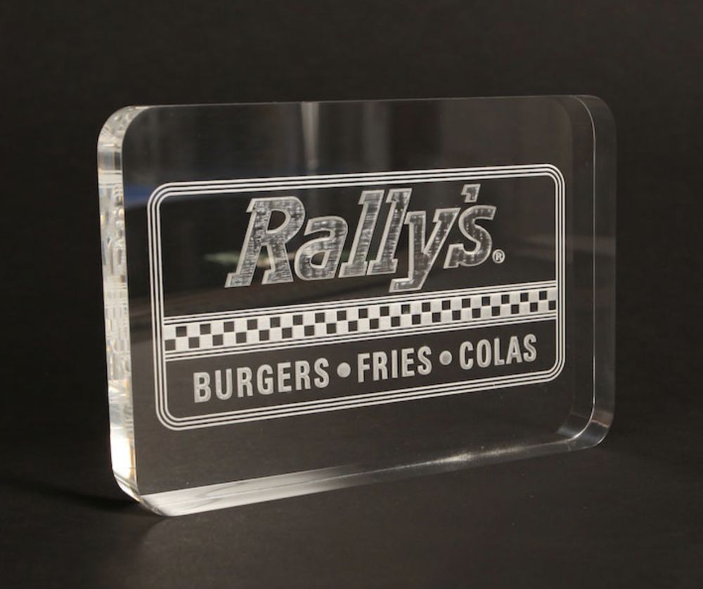Thick clear acrylic block with a frosted engraved restaurant logo