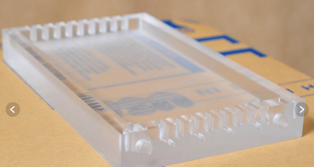 Clear acrylic tray with cut slots along both edges