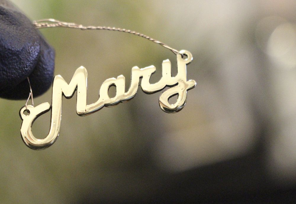 Polished laser cut script name necklace on a chain