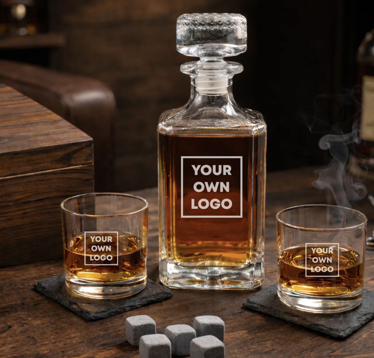 Whiskey decanter and two rocks glasses etched with a logo