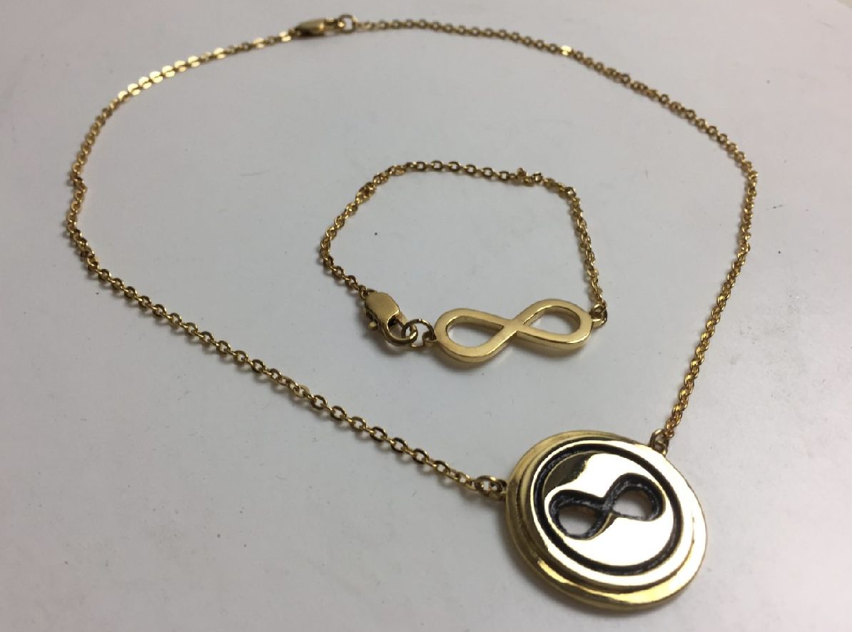 Gold necklace and bracelet set with an infinity symbol pendant