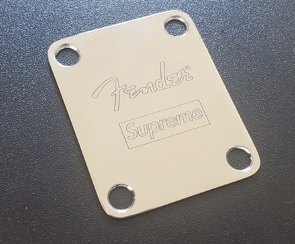 Polished chrome guitar neck plate with fine-line engraved logos