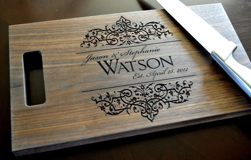 Walnut cutting board with laser engraved names and scrollwork